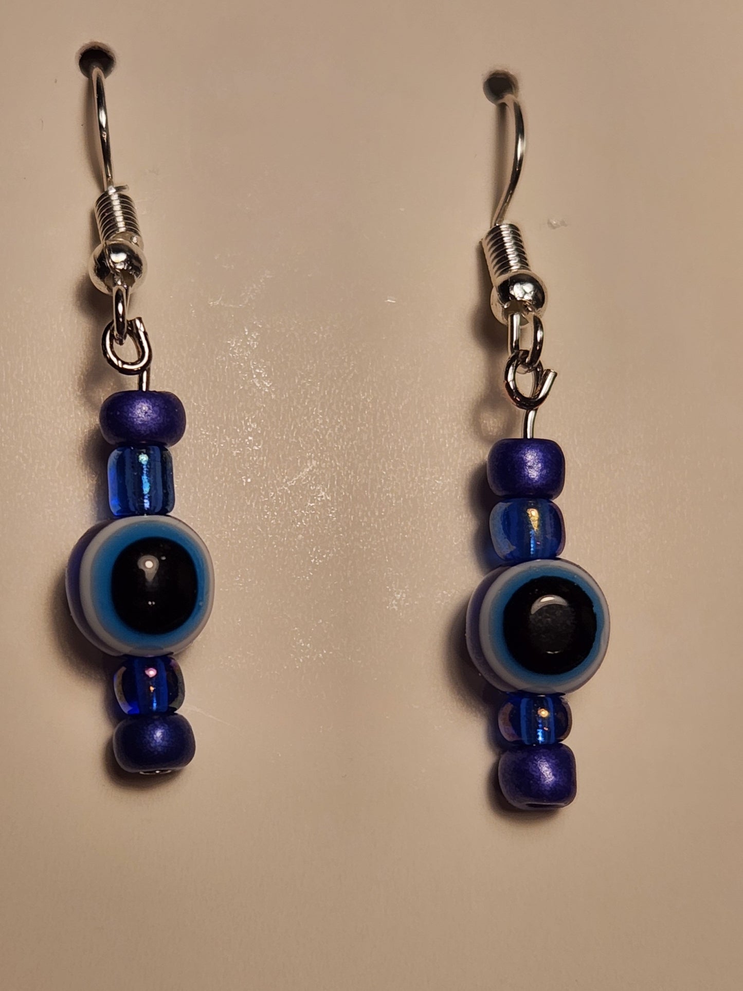 Ojo earrings with blue beads